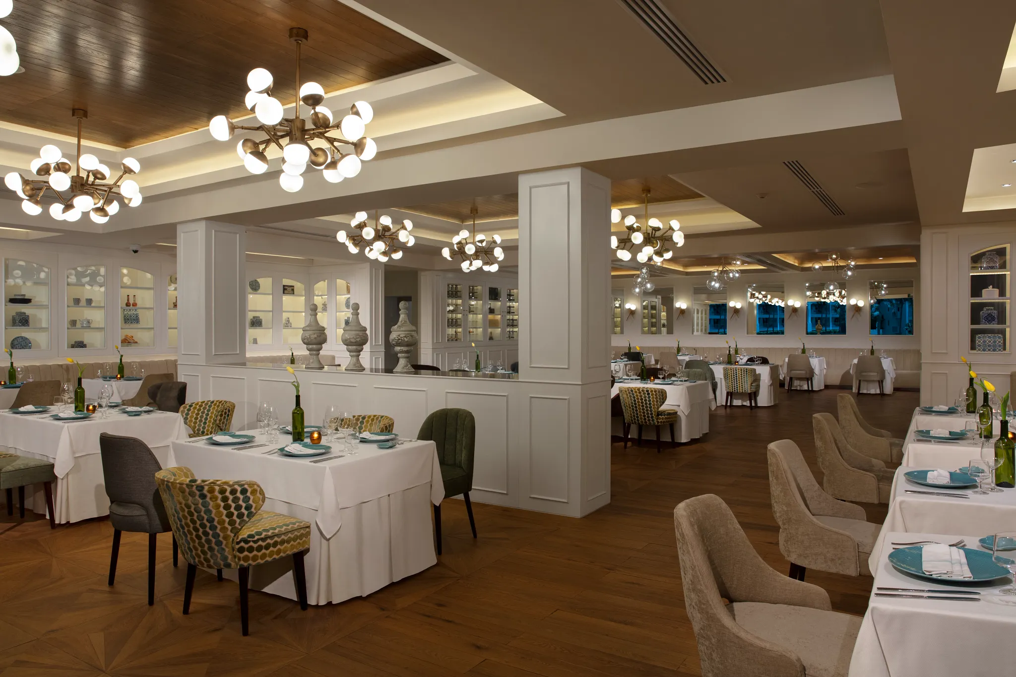 Capers Italian restaurant at Dreams Jade Resort & Spa featuring elegant dining tables, warm lighting, and Tuscan-inspired décor.