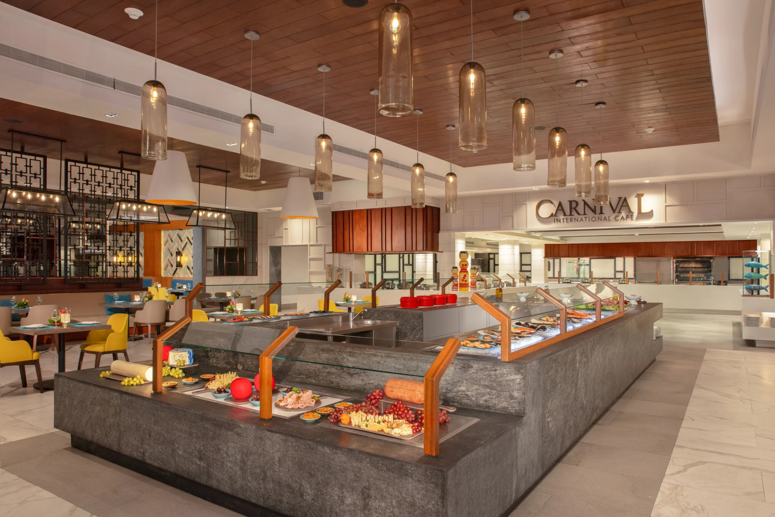 Carnival International Buffet at Dreams Jade Resort & Spa featuring a modern buffet station, fresh international dishes, and bright air-conditioned dining area.