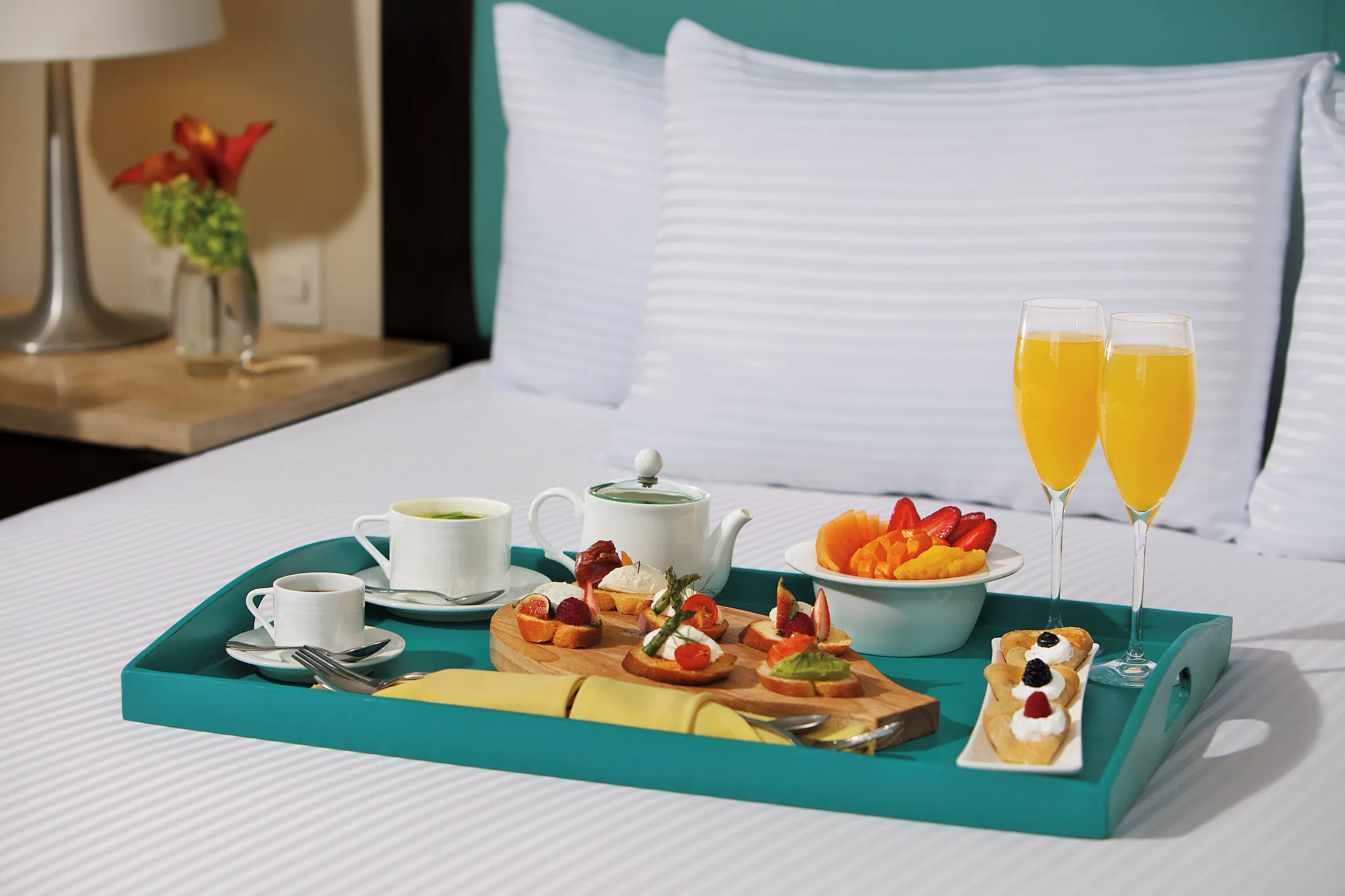 Room service breakfast with fresh fruit and mimosas at Dreams Jade Resort & Spa.