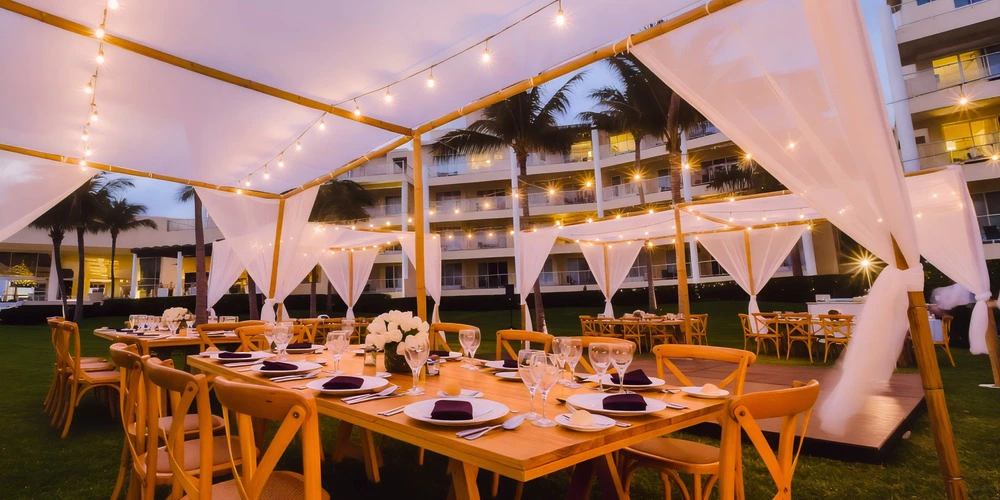 Garden reception setup with draped canopy and string lights at Dreams Jade Riviera Cancun