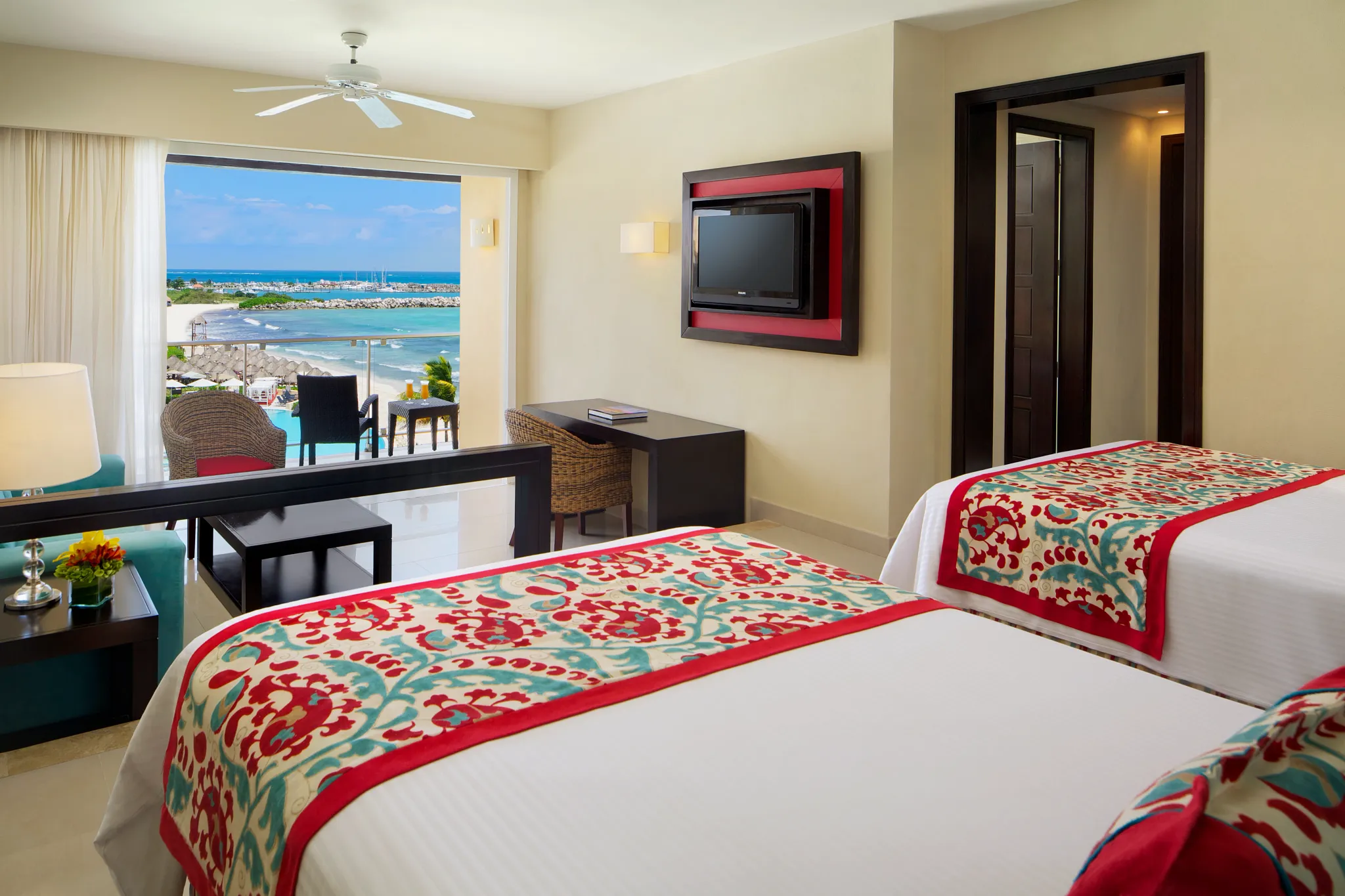 Junior Suite Ocean Front View with two double beds and private balcony overlooking the Caribbean at Dreams Jade Resort & Spa.
