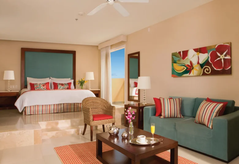 Junior Suite with king bed, tropical view balcony, and spacious living area at Dreams Jade Resort & Spa.