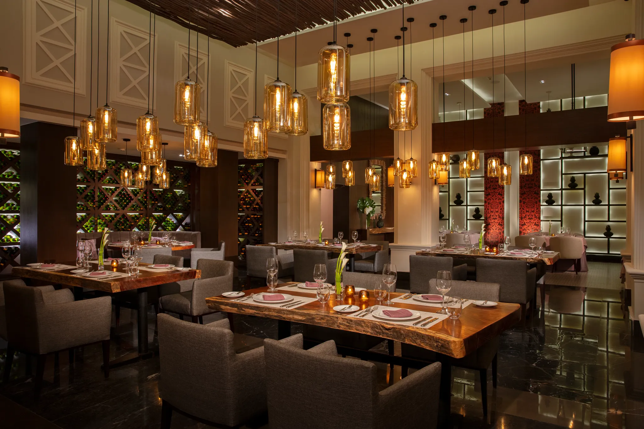 Tamarindo Mexican restaurant at Dreams Jade Resort & Spa featuring elegant dining tables, warm lighting, and contemporary Mexican décor.